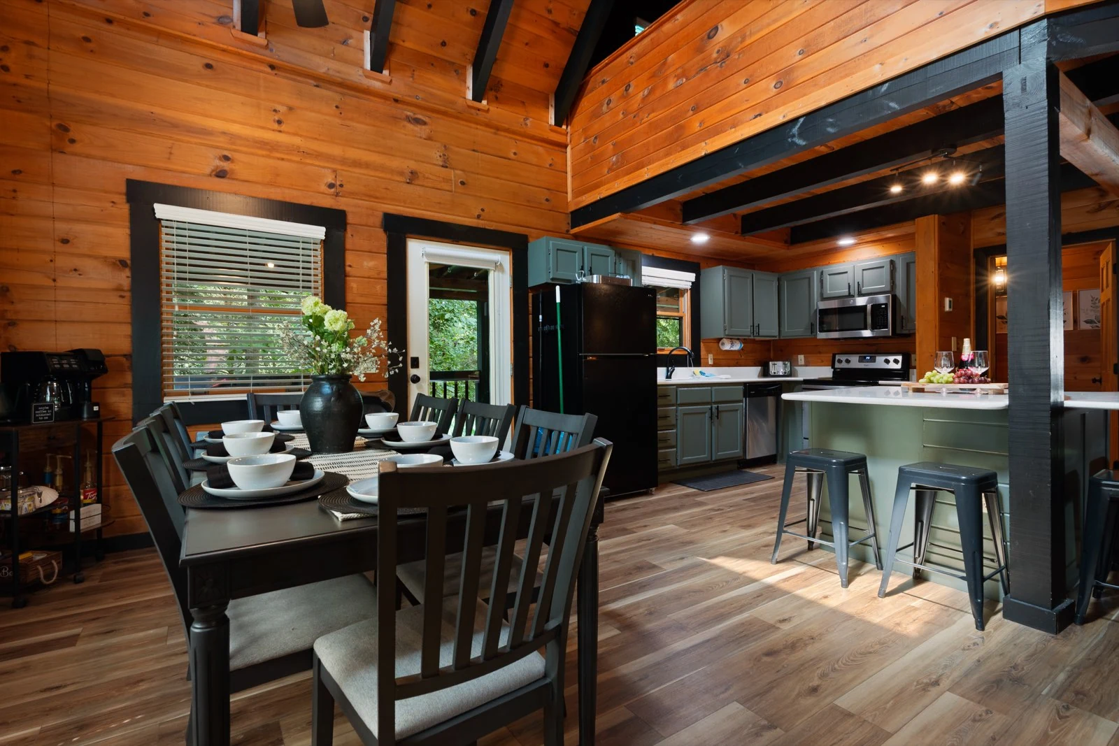 Dining table leading into the kitchen, showing the open gathering space